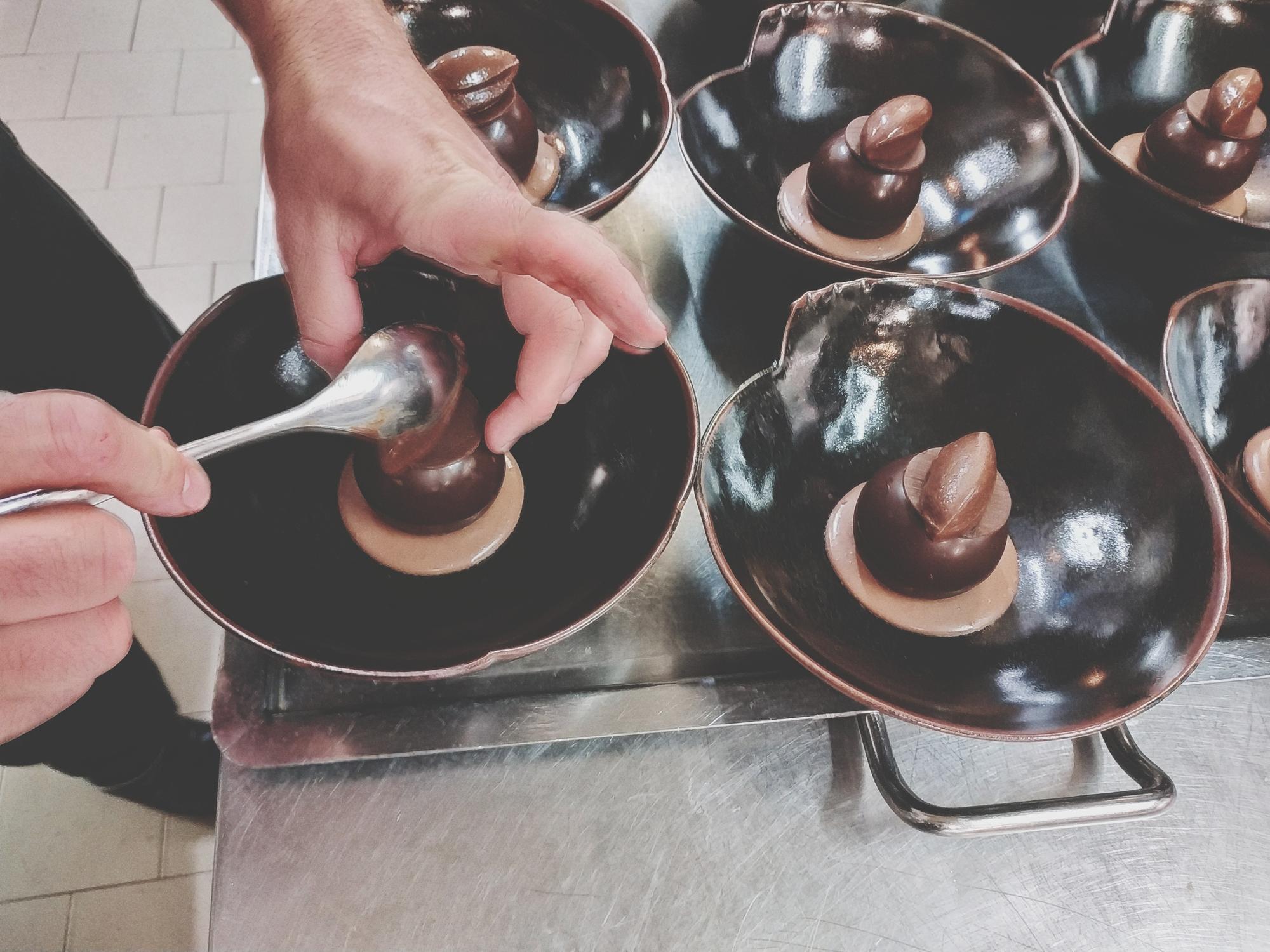 Workshop kitchen with chefs and copper pans